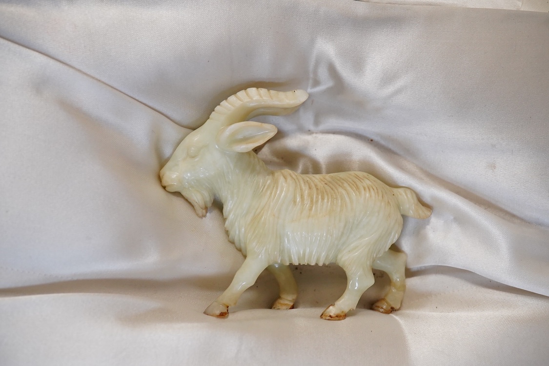 A Chinese silk brocade box containing six Chinese hard stone coloured carved animals and a wooden and metal inlaid stand, largest a horse 19cm wide